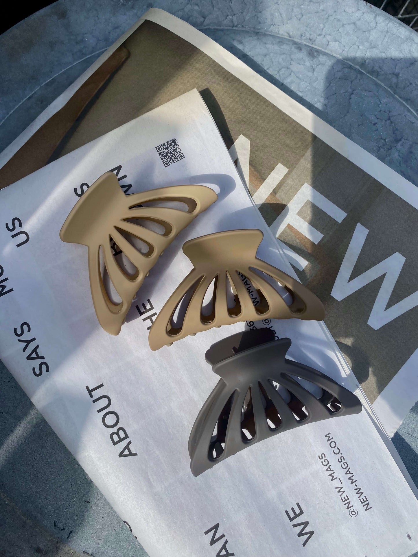 Tre Rounded Claw hårklemmer placeret ved siden af hinanden i naturligt lys.